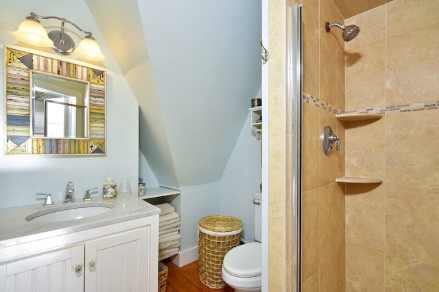 bathroom featuring vanity, toilet, and a shower with door