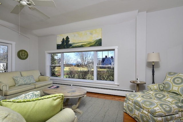 living room with hardwood / wood-style floors, ceiling fan, and a baseboard radiator