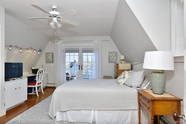 bedroom with french doors, access to outside, ceiling fan, dark wood-type flooring, and lofted ceiling