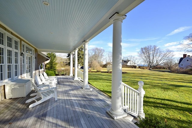 wooden deck with a porch and a yard