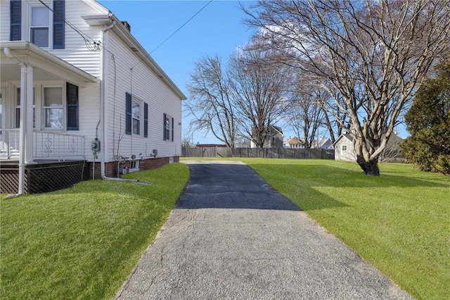 view of side of property with a lawn