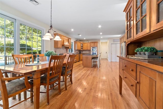 dining space with light hardwood / wood-style flooring