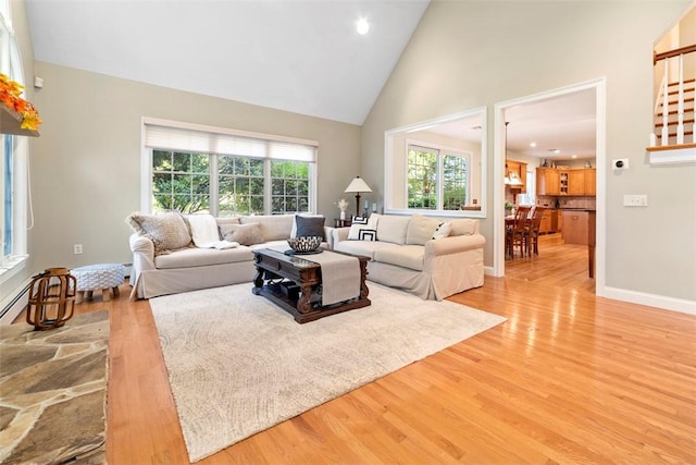 living room featuring light hardwood / wood-style flooring and high vaulted ceiling