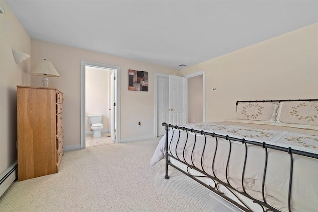 bedroom with light colored carpet, ensuite bath, and baseboard heating