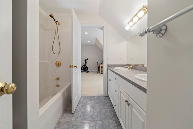 bathroom with vaulted ceiling, vanity, and bathtub / shower combination