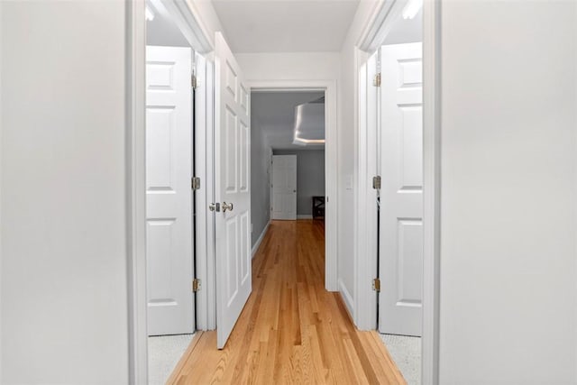 hallway with light hardwood / wood-style flooring