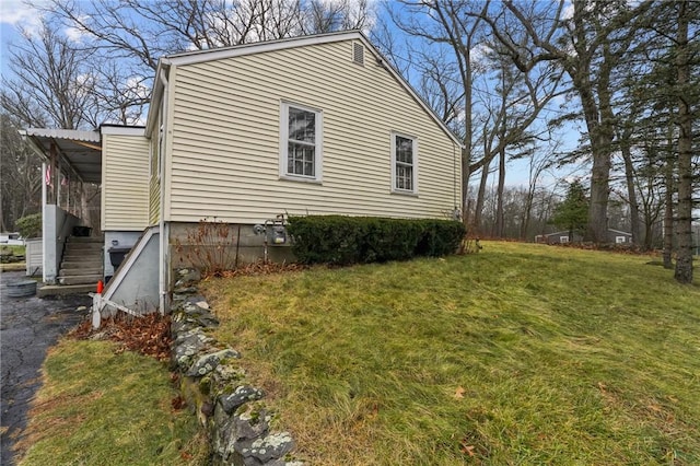 view of home's exterior with a lawn