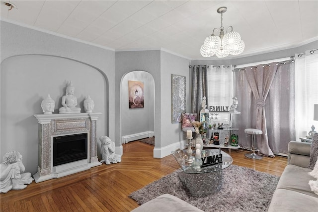 living room featuring a baseboard heating unit, crown molding, hardwood / wood-style floors, and a chandelier