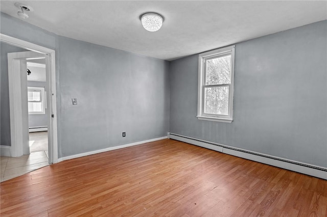 spare room with light hardwood / wood-style flooring and baseboard heating