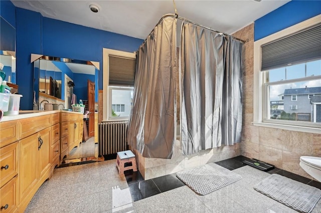 bathroom with radiator heating unit and vanity