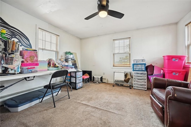 carpeted office featuring ceiling fan