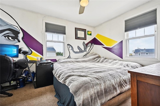 bedroom featuring ceiling fan, refrigerator, and light carpet