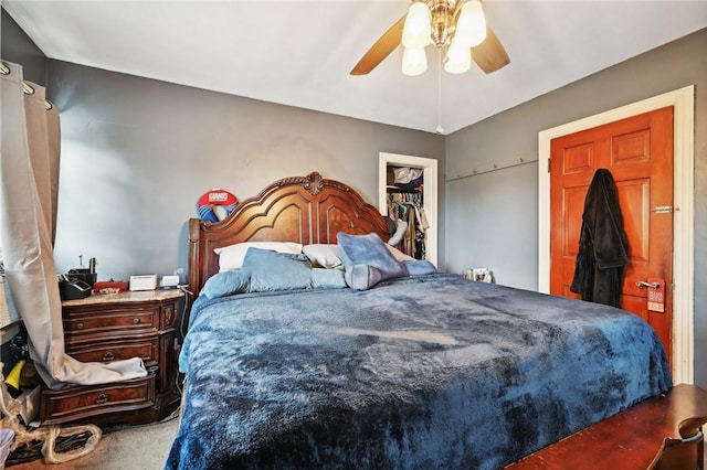 bedroom with carpet, ceiling fan, a walk in closet, and a closet