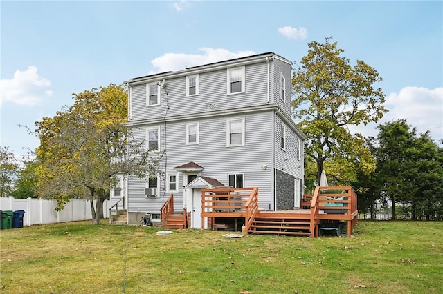 back of property with a yard and a wooden deck