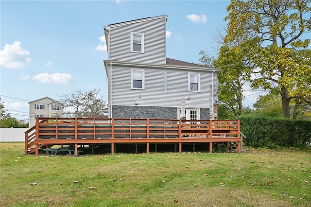 rear view of property with a lawn and a deck