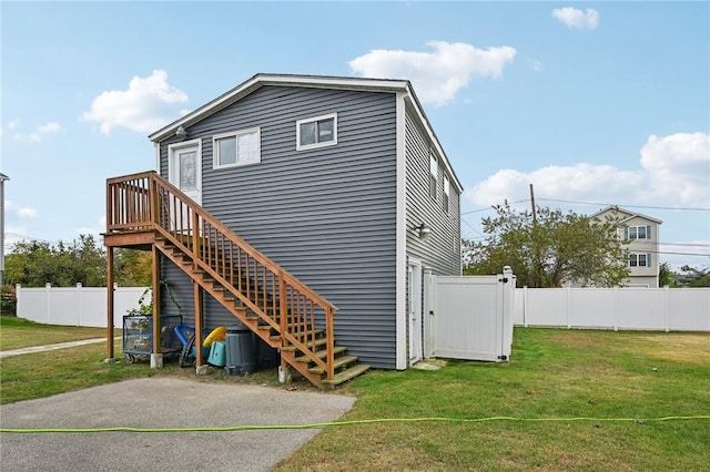 rear view of property with a yard