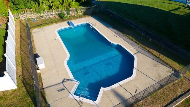 view of pool featuring a lawn and a patio