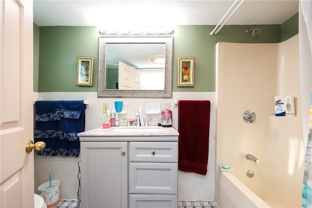 full bathroom featuring vanity, toilet, shower / bath combination, and tile walls