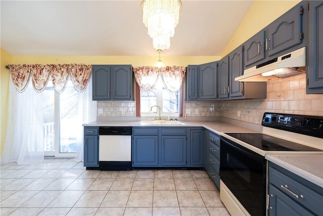 kitchen with blue cabinetry, sink, a chandelier, white appliances, and light tile patterned floors