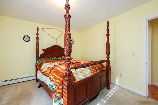 bedroom with light colored carpet and a baseboard radiator