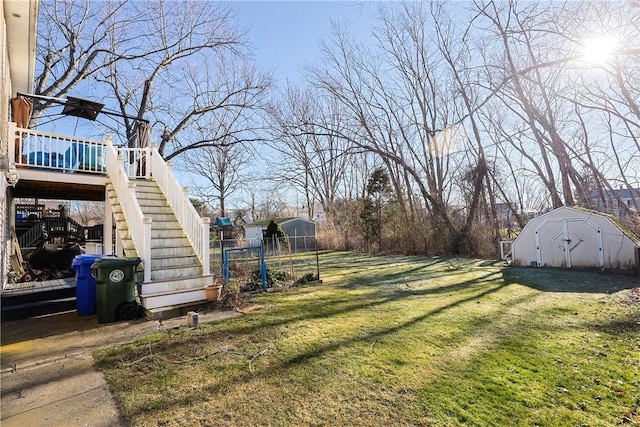 view of yard featuring a wooden deck and a shed