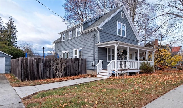 view of front of house with a porch and a front lawn