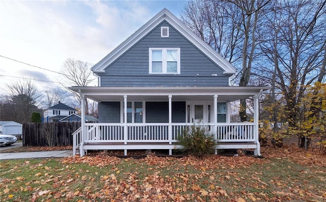 view of front of house featuring covered porch and a front lawn