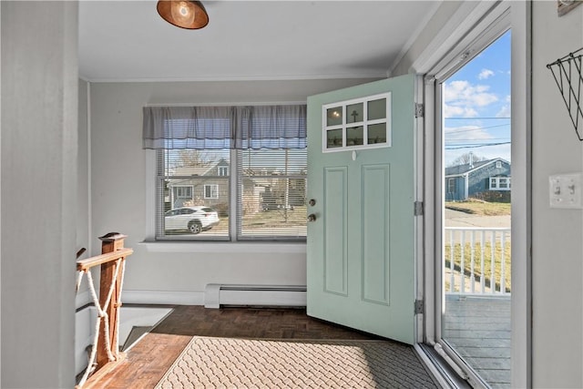 doorway to outside with ornamental molding and a baseboard heating unit