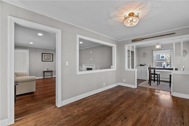 dining area featuring crown molding, dark wood-type flooring, and an inviting chandelier