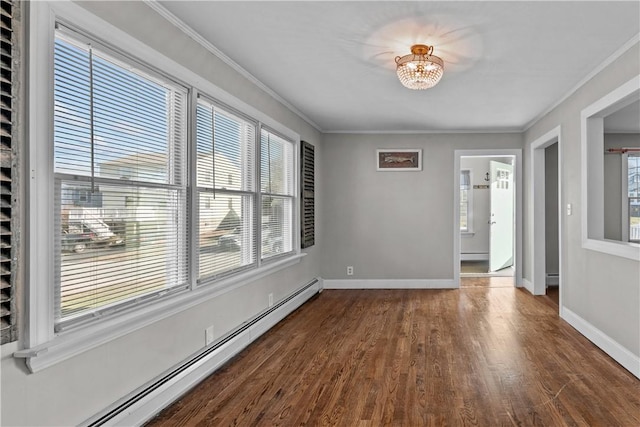 spare room with an inviting chandelier, dark hardwood / wood-style flooring, crown molding, and a baseboard radiator