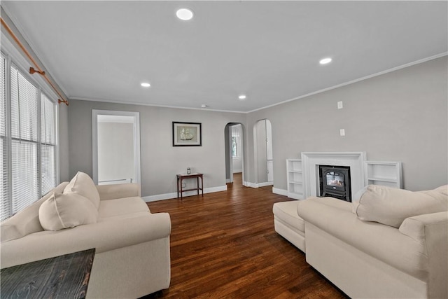 living room featuring ornamental molding and dark wood-type flooring