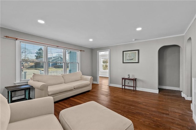 living room with ornamental molding and dark wood-type flooring