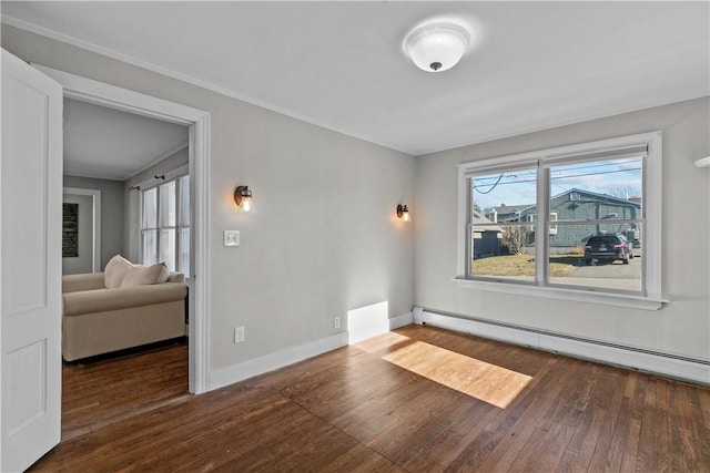 empty room featuring dark hardwood / wood-style floors and a baseboard radiator