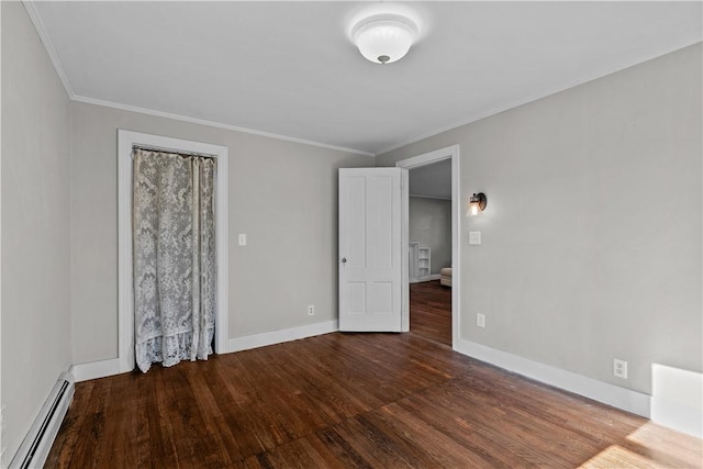 spare room featuring crown molding, wood-type flooring, and baseboard heating