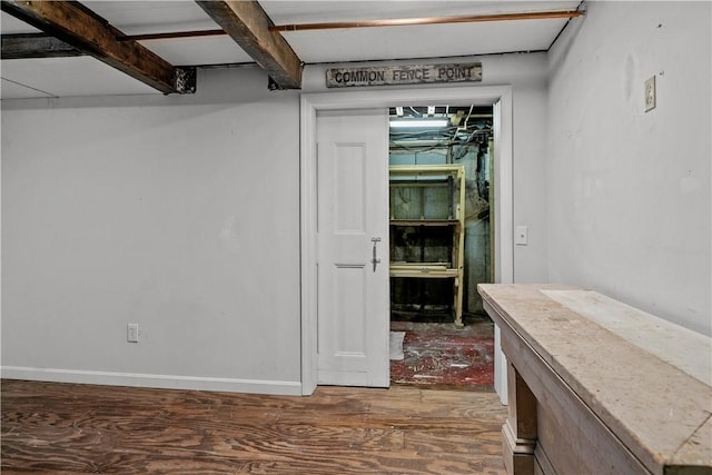 interior space featuring beamed ceiling and wood-type flooring