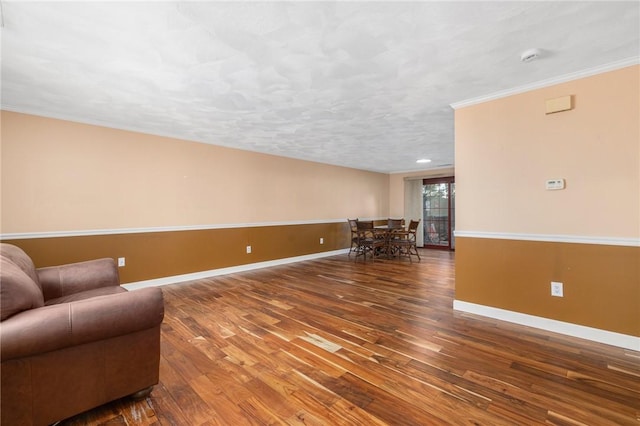 sitting room featuring hardwood / wood-style flooring and ornamental molding