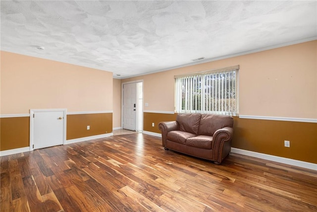 unfurnished room featuring crown molding and hardwood / wood-style flooring