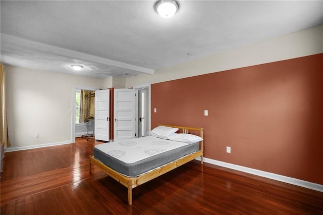 bedroom with dark wood-type flooring