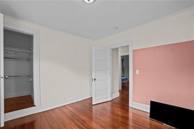 unfurnished bedroom with a closet and hardwood / wood-style flooring