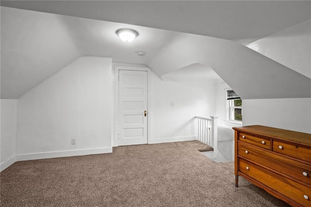 bonus room featuring light carpet and lofted ceiling