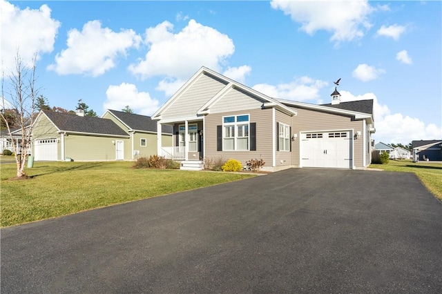 view of front of home with covered porch, a garage, and a front lawn