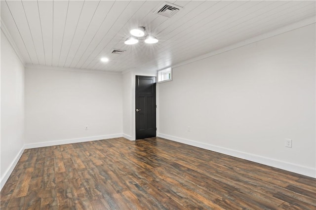 spare room featuring crown molding, dark hardwood / wood-style flooring, and wood ceiling