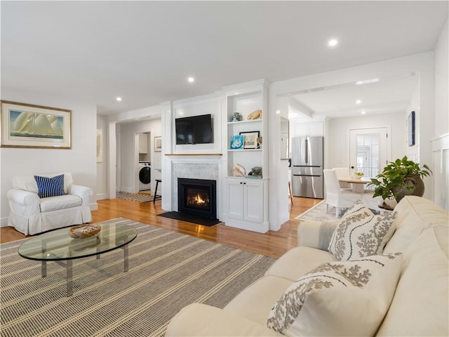 living room with light hardwood / wood-style floors and washer / clothes dryer