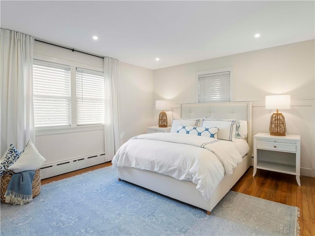 bedroom featuring dark hardwood / wood-style floors and a baseboard radiator