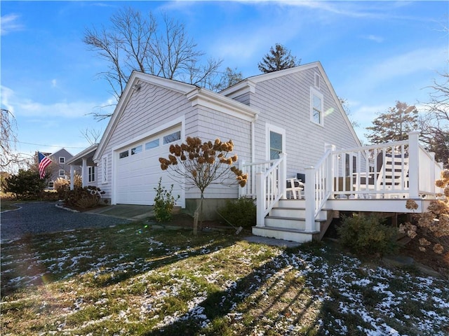 view of side of home with a garage and a deck