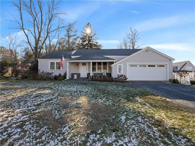 ranch-style house with a porch and a garage