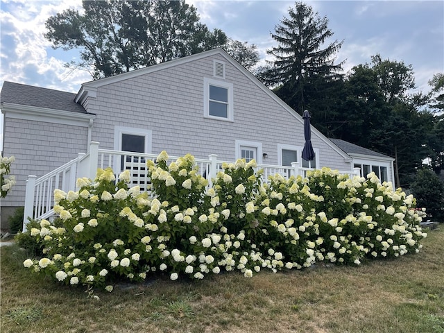 view of home's exterior with a yard and a wooden deck