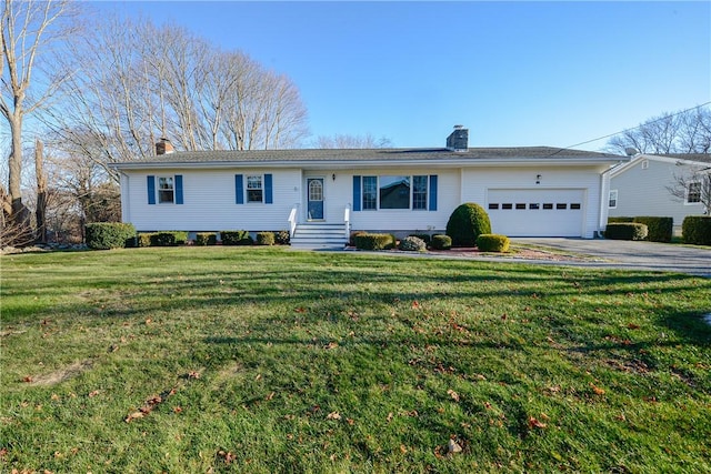 ranch-style home featuring a garage and a front lawn