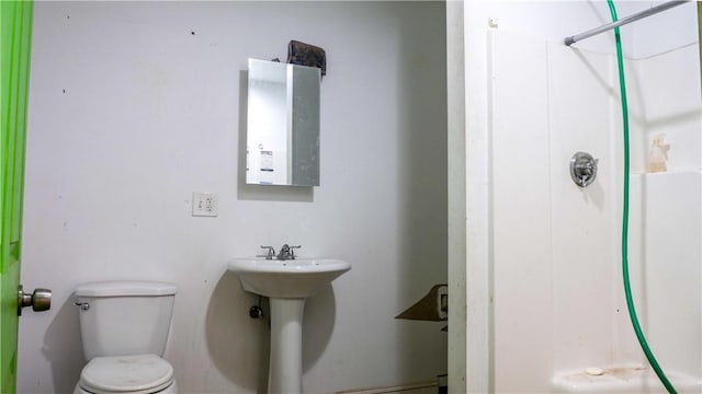 bathroom with a shower and toilet