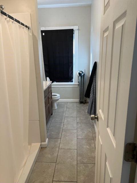 bathroom featuring tile patterned floors, a shower with curtain, vanity, and toilet